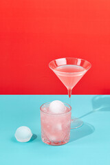 Multi-colored cocktails in glasses of different shapes on colored backgrounds with hard shadows