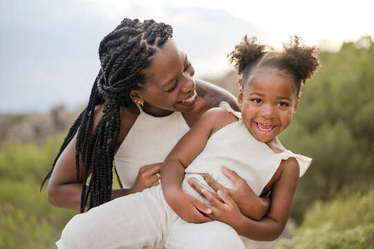 African American Mom Playing With Daughter In Nature