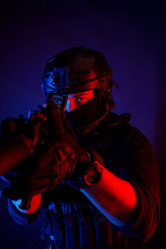 Anonymous male soldier in protective uniform aiming with rifle