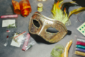 Carnival mask in the process of decoration and materials for its decoration. DIY masquerade mask...