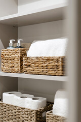Organizers bathroom cabinet full of bath cosmetics and clean towels