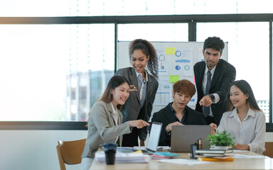 Young happy Asian business man, woman work together, celebrate success in start up office. Creative team brainstorm meeting, businesspeople colleague partnership or office coworker teamwork concept
