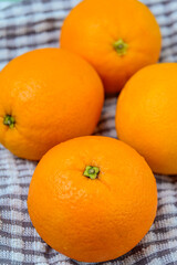 Four Whole Oranges on a cloth background