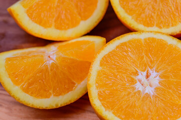 Sliced oranges on a wood background