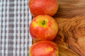 Apples on a wood background with cloth to the left