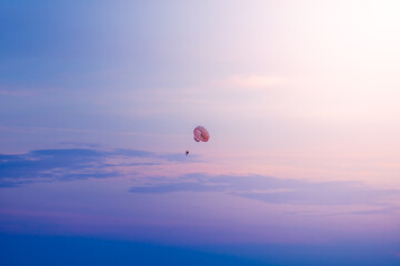 Parasailing in blue sky on sunny day