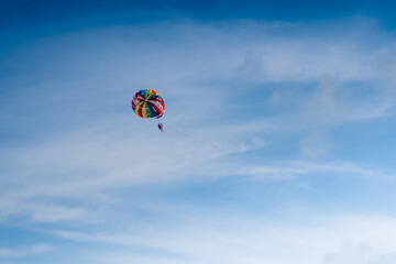 Parasailing in blue sky. Sports, active leisure, travel, vacation concept