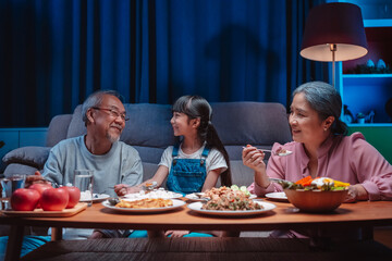 Asian happy family having lunch on dinner japanese table smiling together. little kid daughter enjoy eating food grandparents. Happiness time people lifestyle concept.