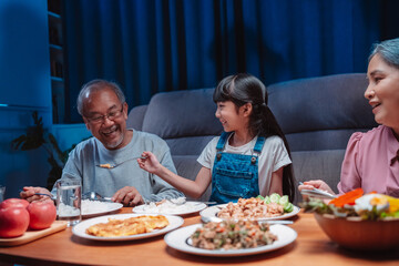 Asian happy family having lunch on dinner japanese table smiling together. little kid daughter enjoy eating food grandparents. Happiness time people lifestyle concept.