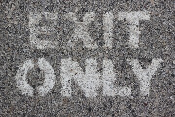 Ext only sign painted on a concrete wall.