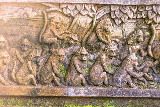 Monkeys are depicted on a stone wall