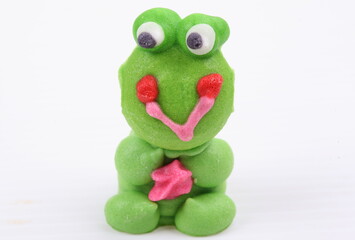 Doll made of colored sugar isolated on white