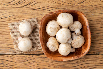Paris mushrooms in a bowl over wooden table