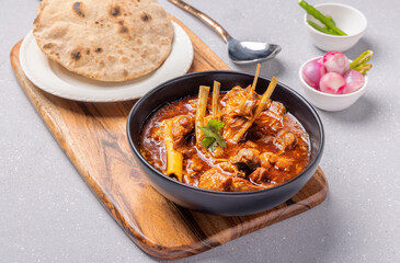 home cooked mutton gravy or mutton curry  with roti and onion salad