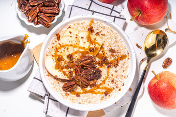 Simple autumn traditional American breakfast. Ready to eat apple pie oatmeal porridge with apples,...