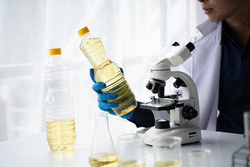 Quality control in oil refining industry concept. Male chemist hold test tube with yellow liquid biological research closeup.