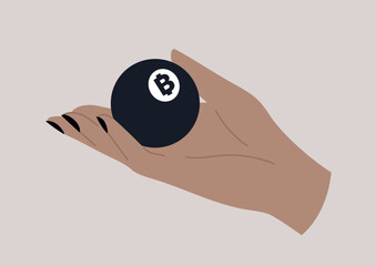 A hand holding a black lottery ball with a bitcoin sign