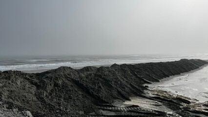 waves crashing on dark sand