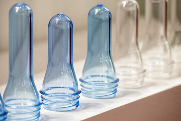 The close up scene of group of preform shape of PET bottle products. The raw material for plastic...