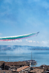 Tricolor arrows, the Italian aerobatic team, flying over Lake Garda - 532207714