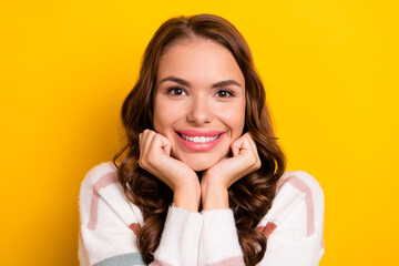 Photo of stunning satisfied person arms touch cheeks beaming smile isolated on yellow color background