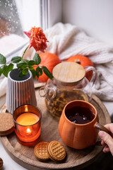 Rainy autumn day. A cup of tea and cookies on the windowsill. Cozy still life