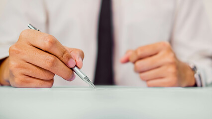 Businessman signing consent documents.