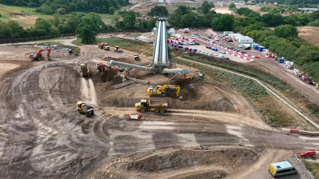 Tipper Trucks Being Loaded Up With Earth From a Conveyor