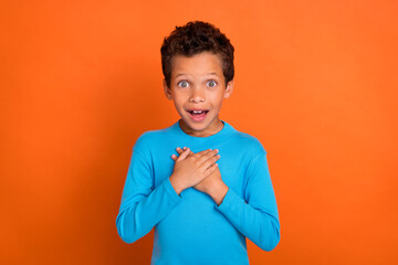 Photo of astonished impressed boy arm breast unexpected unbelievable reaction win winner isolated...