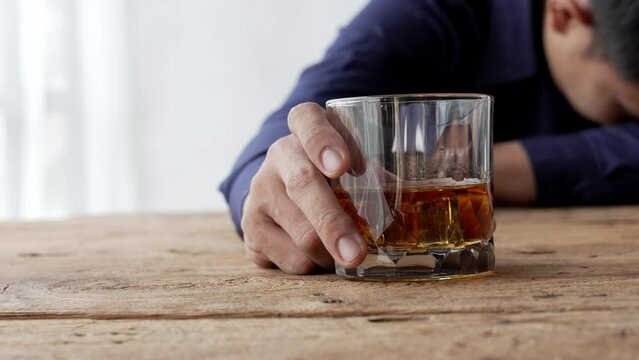 Alcoholism concept. Young man drinking alcohol too much. drunk asian man hold whisky glass addicted alcohol need therapy.