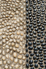 close up of black and white stones on the ground, background