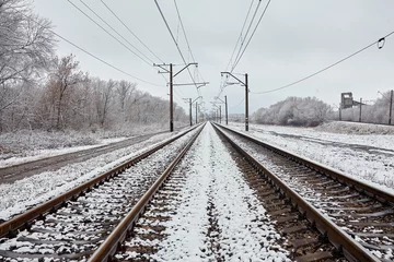 Poster Train tracks in winter with frost covering around everywhere © Ryzhkov Oleksandr