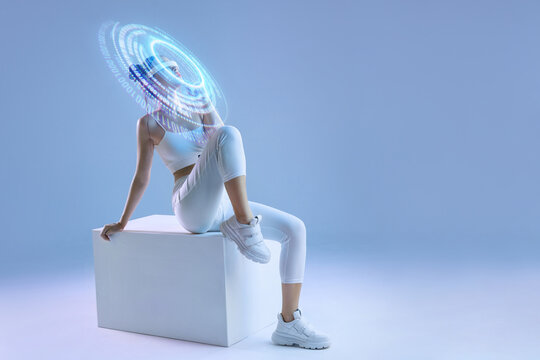 Woman in modern VR glasses interacting with network while having virtual reality experience. Augmented reality game, future technology, AI concept. VR. Holographic interface to display data. - Powered by Adobe