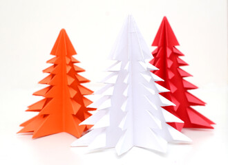 Colorful origami christmas trees on white