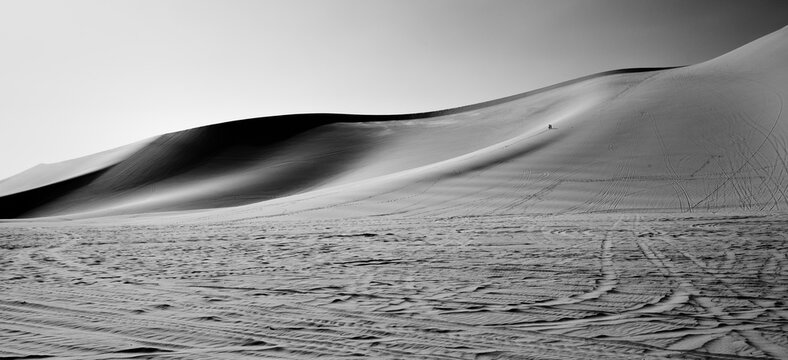 Car tire tracks in sand dunes