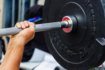 Weightlifting. The process of bench press with the wrong grip. Inept handling of the barbell during...