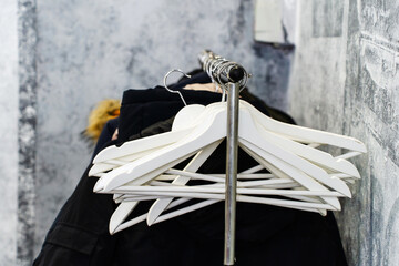 White wooden hangers in the cafe public cloakroom. Close-up