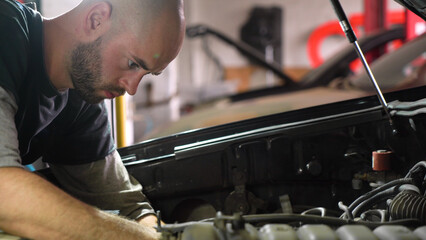 auto mechanic repairs car engine. car service. close-up.