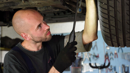 Car diagnostics. an auto mechanic inspects a car. auto repair shop. breaking. transmission