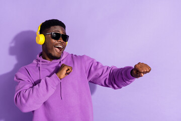 Photo of handsome man enjoy free time weekend favorite playlist isolated on purple color background