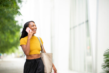 Happy woman talking on cellphone in city