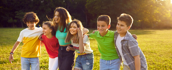 Happy kids playing outdoors. Cheerful friends enjoying summer holidays together. Group of children...