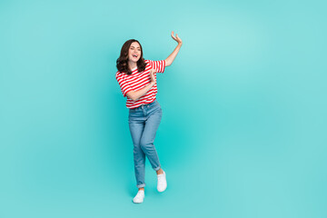 Full length photo of overjoyed nice lady rejoice holiday weekend empty space wear striped trendy outfit isolated on cyan color background