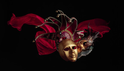 Old carnival masks with flutters red cloth.