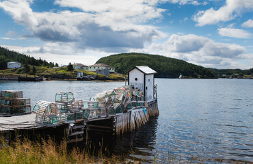 Wharf and lobster pots in rural Newfoundland community on the ocean.
