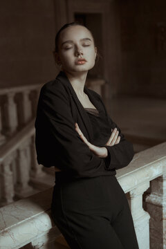 Portrait of a young girl in a classic black jacket with closed eyes