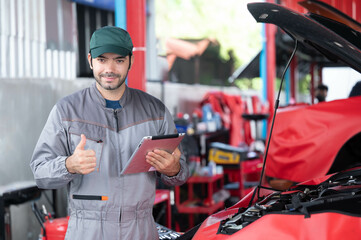 car service, repair, maintenance concept - Arab auto mechanic man or Smith stand beside a car at workshop warehouse before start checking a car in the garage for maintenance services