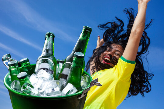 woman celebrating goal drinking beer