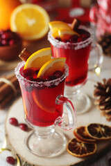 Glasses with warm cranberry with oranges drinks