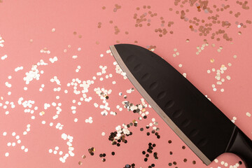 Kitchen knife on pink background